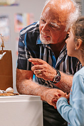 Neuberger 072424-92 Older gentleman and young child examining a sculpture on a pedastal